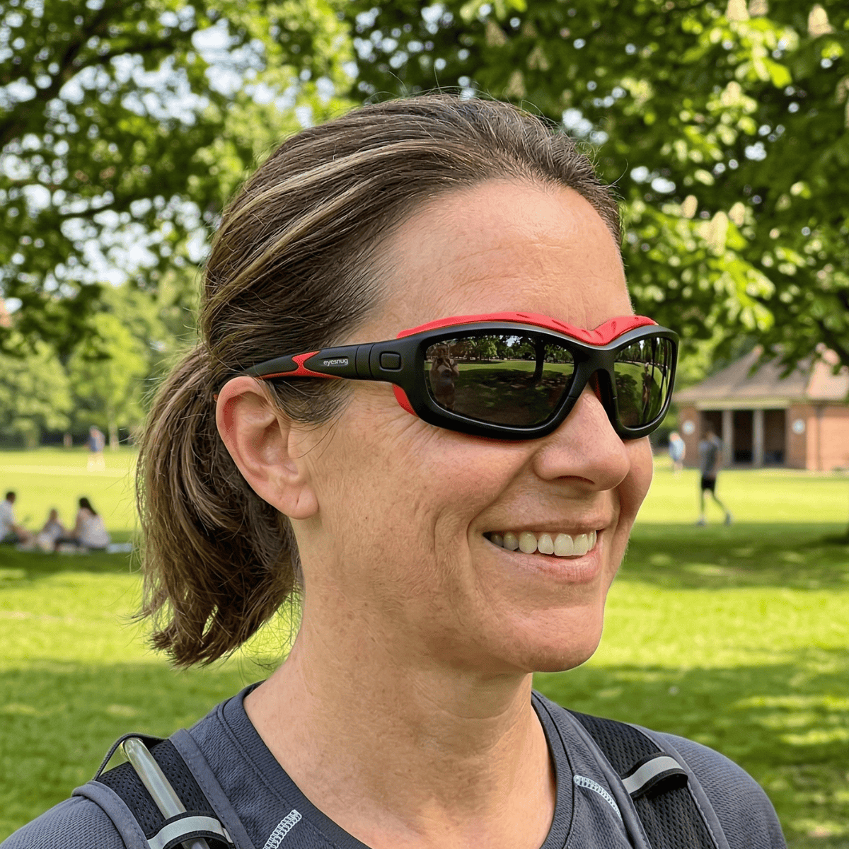 Runner in a hydration vest wearing red and black Eyesnug Pursuit sunglasses