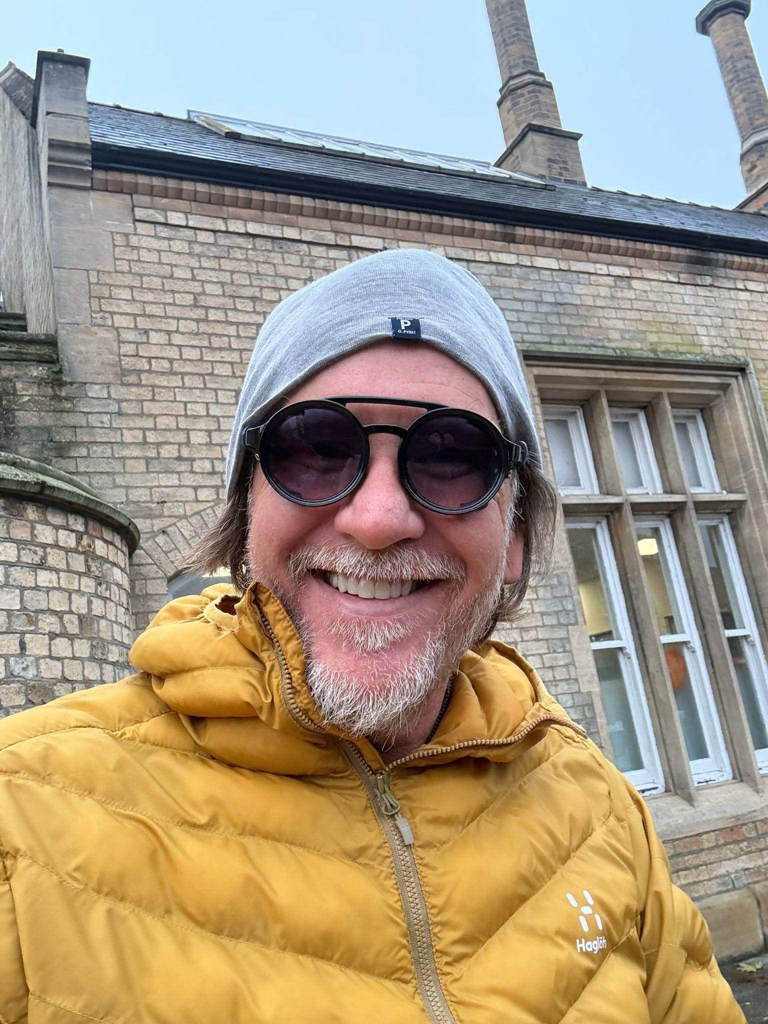 Eyesnug wearer smiling outdoors in a yellow jacket